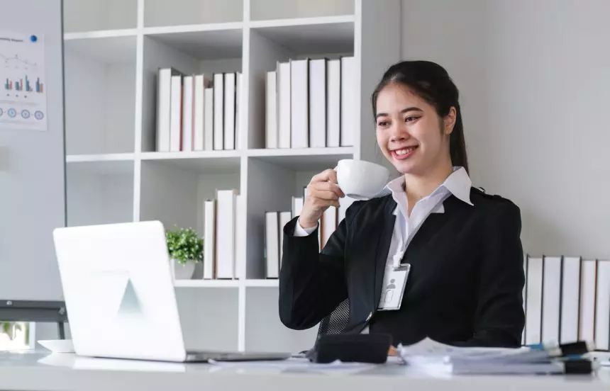 Successful Asian businesswoman sitting in modern office Use your laptop to manage your work