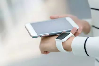 Woman connecting smart watch and cellphone